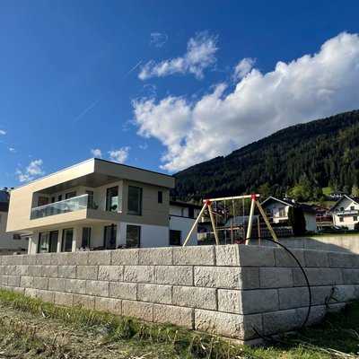 Hanglage perfekt genutzt: Stützwand schafft Platz für Garten und Spielbereich